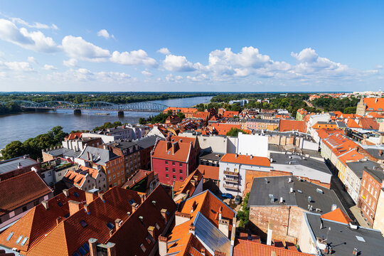 view of the old town of Torun and the Vistula river from above during a warm summer day.