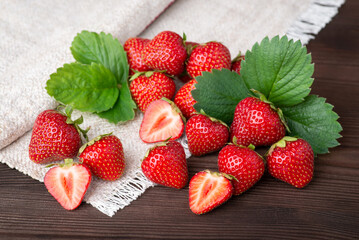 Tasty strawberries with green leaves. Beautiful studio composition of strawberries