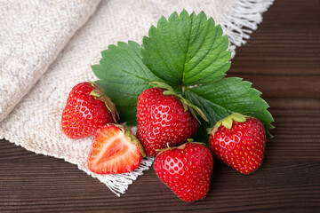 Tasty strawberry on black table with white natural towel. Tasty strawberries