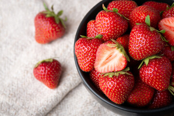Close-up photo of red fresh strawberry. Bowl full of ripe strawberries