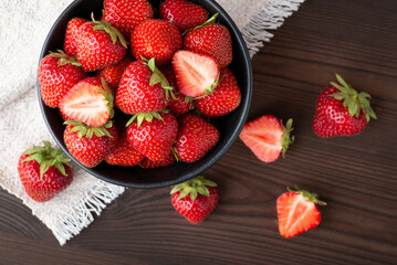 Top-down shot of strawberry on black wooden table. Fresh tasty strawberry