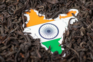 Map of India in black tea leaves. Concept of growing tea in India