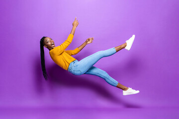 Cheerful black woman falling in studio