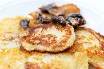 Fresh fried potato pancakes with roasted mushrooms