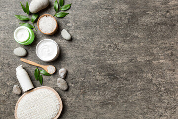 Coconut with jars of coconut oil and cosmetic cream on colored background. Top view. Free space for your text. Natural spa coconut cosmetics and organic treatment concept Coconut Spa composition