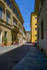 Parma, Italy: Old city streets on a sunny day and Palazzo Pilotta in the back of the street