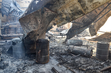 Burned and damaged industrial complex. Burned factory. Remnants of burnt down building. Fire damage. Damaged industrial halls.