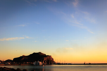 Sunrise at Foro Italico Coast of Palermo on Sicily in Europa, Italy in late spring April on a warm sunny orange day