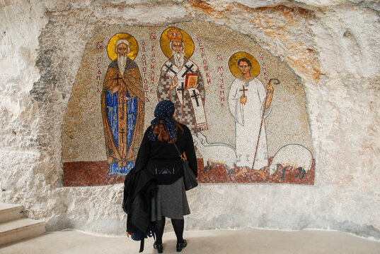 Pilgrim in front of an icon in Ostrog Monastery in Montenegro. Women are praying in Manastir Ostrog.  