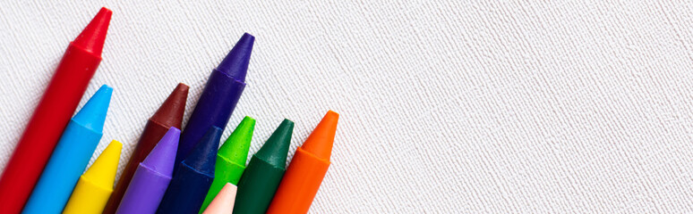 top view of set with colorful crayons on textured white background, banner. - obrazy, fototapety, plakaty