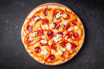 hot delicious traditional italian pizza on a dark stone background