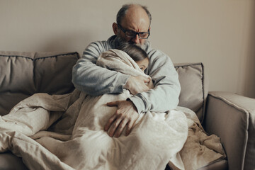 Ukrainian excited gray-haired man protects his little frightened granddaughter. Stop the war. Pray for Ukraine. We support Ukraine.