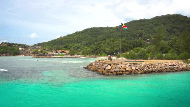 The flag of Seychelles in the port of La Digue island