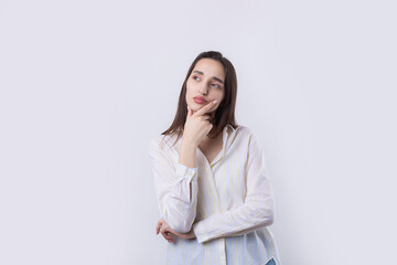 Obraz premium Portrait of a beautiful young woman thinking, isolated on white background