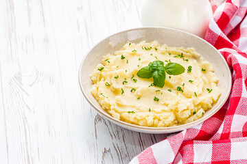 fresh tasty mashed potatoes on a white wooden rustic background