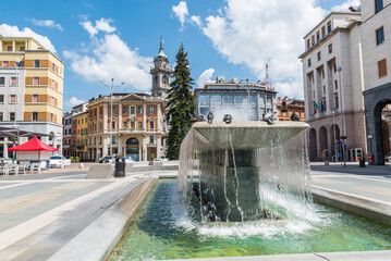 Varese city, Italy. Square Monte Grappa and historic center with fountain and the bell tower...