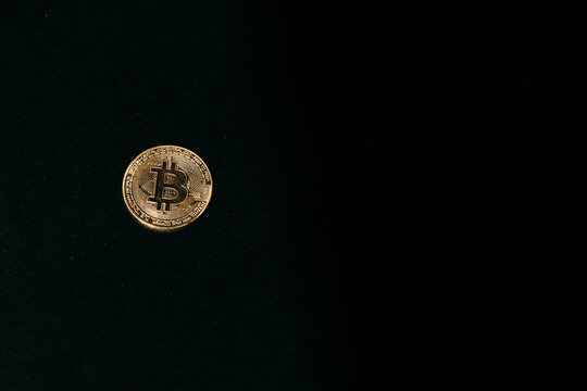 Classic gold bitcoin on dark background