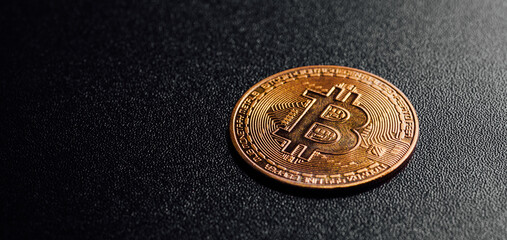 Gold bitcoin on the dark background. Conceptual picture of digital money.