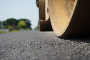 The image is blurred in the construction of asphalt road. - obrazy, fototapety, plakaty