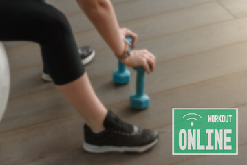 sign online workout, due to the closure of the hall during the lockdown. close up Young athletic woman training with exercise ball and dumbbells