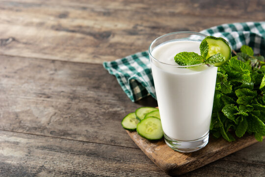 Ayran drink with mint and cucumber in glass. Copy space
