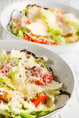 Caesar salad on a white wooden rustic background