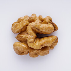 dried walnuts on a white acrylic background