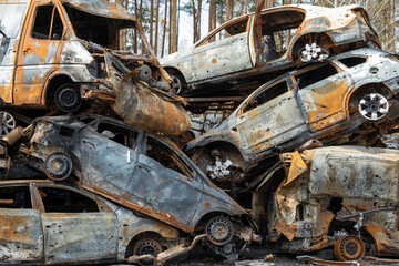Many shot and destroyed cars of civilians at the car graveyard in Irpin, Ukraine. War in Ukraine....