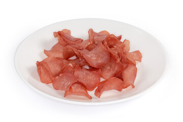 Dried chicken snacks on a white dish close-up