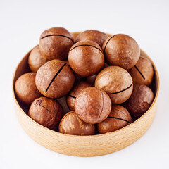fresh macadamia nuts on a white acrylic background