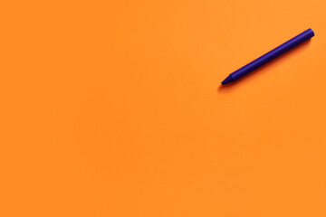 top view of purple crayon on bright orange background. - obrazy, fototapety, plakaty