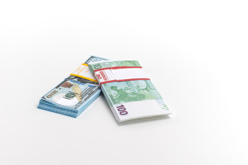 Obraz na płótnie Canvas Two Packs of European and US Banknotes Currencies Placed Together on White Background.