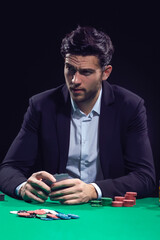 Gaming Concepts. Emotional Handsome Caucasian Brunet Pocker Player At Pocker Table With Chips and Cards While Playing