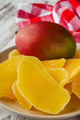 delicious dried mango on a white wooden rustic background