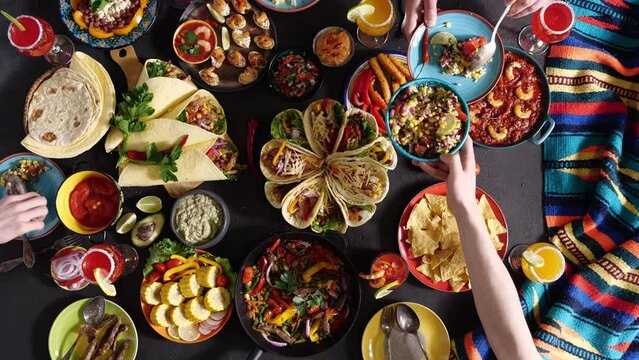 An authentic Mexican family celebrates Cinco de mayo together at a festive table. Mexican food