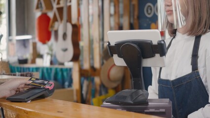 Customer woman using digital wireless or contactless payment using credit card without money for buying coffee in cafe coffee shop, small business accepts digital payment