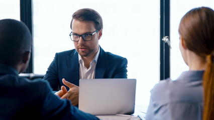 Young director giving new ideas about the project to his business partners