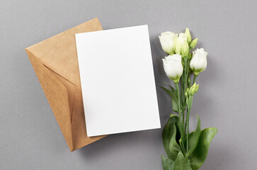 Wedding invitation card mockup with envelope and white eustoma flowers