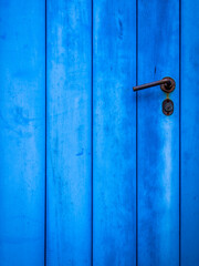 Obraz premium Blue painted door closeup with simple handle, plenty of space for text or logo