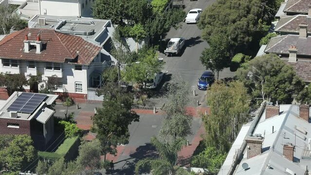 Pedestrians Walking Around Suburb Location On Bright Summers Day.