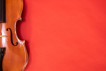 Classical music concert poster with orange color violin on red background with copy space for your text. online music courses. Invitation card with place for text