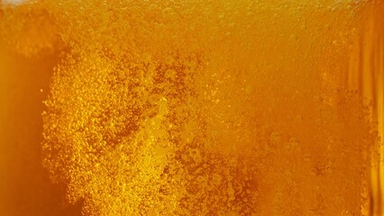 Super slow motion of macro shot of pouring beer drink, close-up. Filmed on high speed cinema camera, 1000 fps. Camera in motion.
