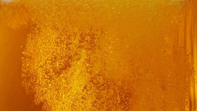 Super slow motion of macro shot of pouring beer drink, close-up. Filmed on high speed cinema camera, 1000 fps. Camera in motion.