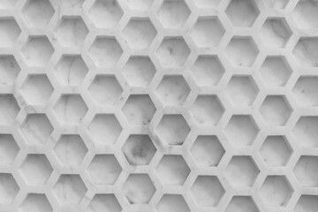 Texture of hexagonal honeycomb made of concrete. Gray decorative background