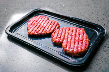 Vacuum pack of two cutlets. Meat cutlet in the shape of a heart. Meat love. Dinner for lovers on February 14. Valentine's Day