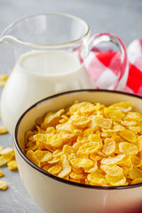 crispy golden cornflakes on a gray concrete background