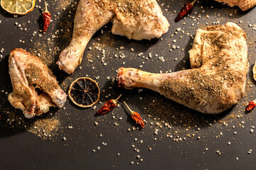 Obraz premium Raw chicken thighs with spices. A useful ingredient for preparing healthy food
