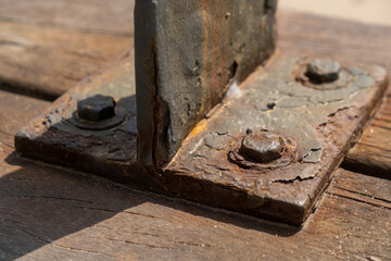 Corrosive rusty bolt close-up. Wood and metal are susceptible to rust.