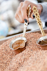 Traditional Turkish, Arabic coffee brewed in hot sand