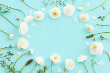 Fototapeta na wymiar Top view image of white flowers composition over blue pastel background